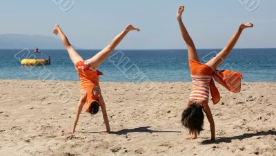 Two girls doing cartwheel