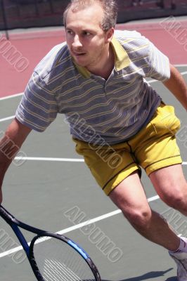 Middleage man playing tennis
