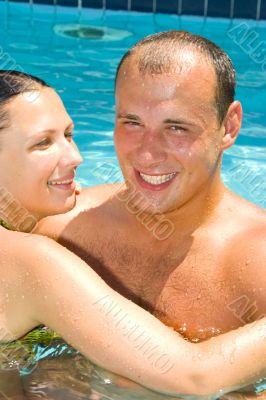 An attractive couple relaxing by the pool