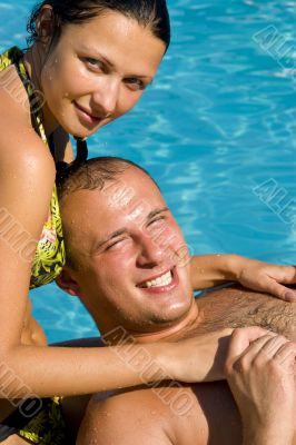 An attractive couple relaxing by the pool