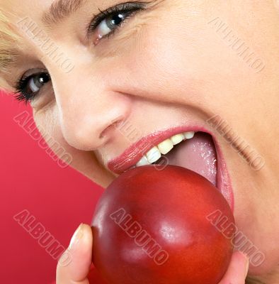 blonde woman with a peach on a red background