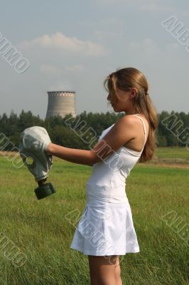 Girl dresses a gas mask