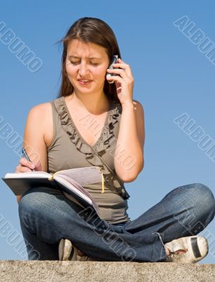 beautiful girl taking notes