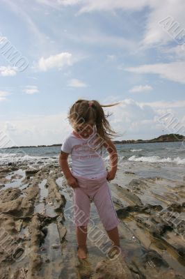 Girl on cloudy coast