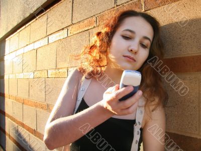 Girl With A Phone At Sunset