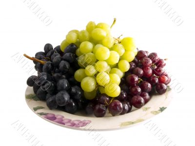 fresh red, black and white grapes on a plate