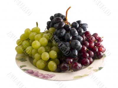 fresh red, black and white grapes on a plate