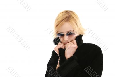 Blonde woman in long black coat