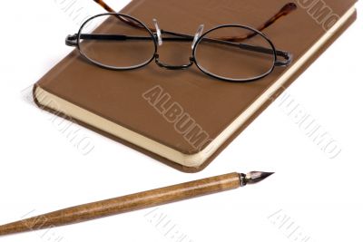 Book with pen and glasses