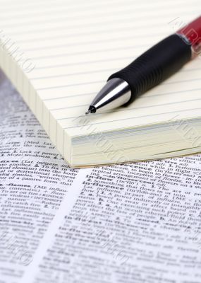 Paper and Pen on Dictionary