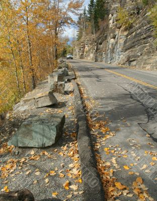 Autumn leaves on narrow mountain road