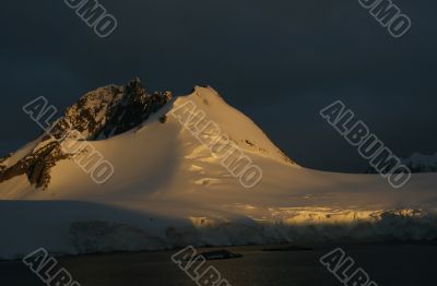 Golden glacier and mountain sunset