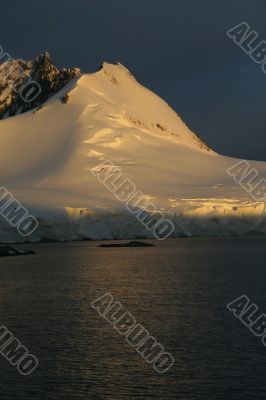 Golden glacier and mountain sunset