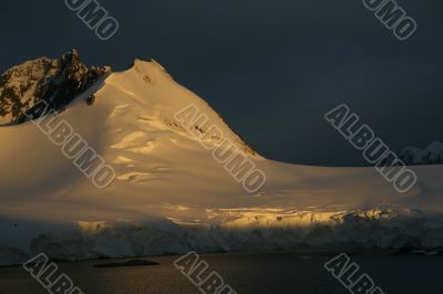 Golden glacier and mountain sunset