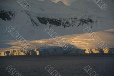 Golden glacier and mountain sunset