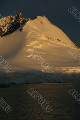 Golden glacier and mountain sunset