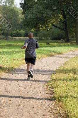 Bold man joging in the park