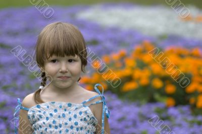 Thoughtful child in floral garden