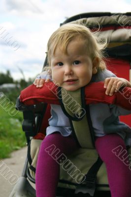 Funny babygirl in pram