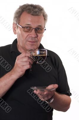 Serious man in glasses drinking coffee