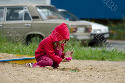 Little girl playing with sand