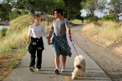 Couple walking their dog
