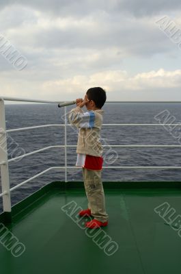 A child boy on deck of cruise ship