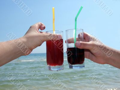 Two man`s hands with glasses of cocktails