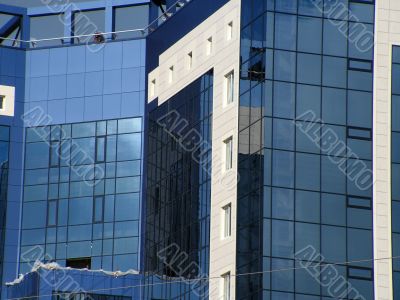 building with blue mirrored windows and white wall