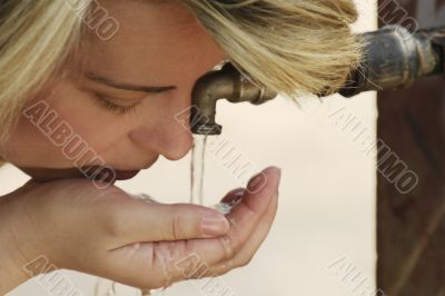 Caucasian young woman drinking water