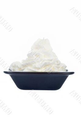 Fresh cream in a black dish