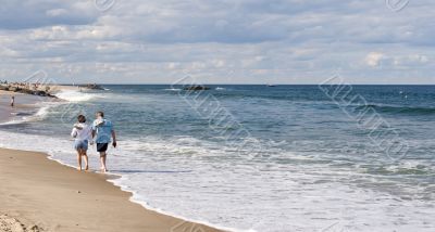 A couple walking along the beach