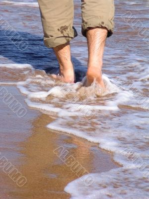Man walking barefood on the beach