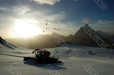 Sunset ski slope snowplow