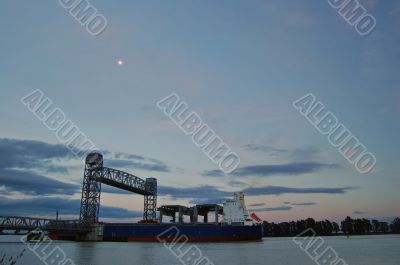 freighter passing under a drawbridge