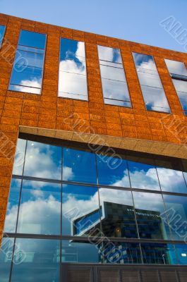 office building windows reflecting clouds