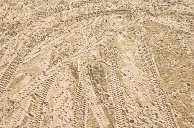 tire tracks on sand at the beach