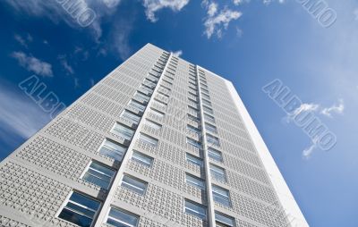 Skyscraper against bright blue sky