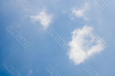 bright blue sky with small fluffy clouds