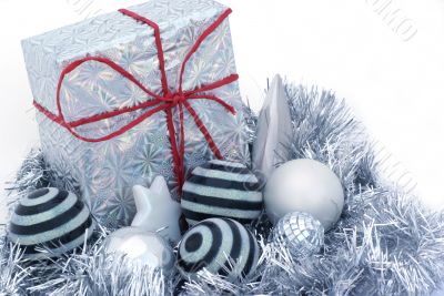 Present surrounded by ornaments.