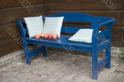 blue bench with apples