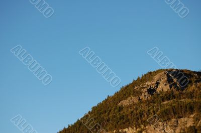 mountainside with blue sky