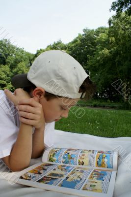 Boy reading cartoon...