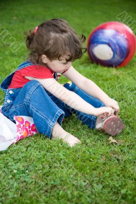 The little girl in park, with the big ball