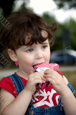 little girl is eating strawberry ice-cream