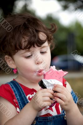 little girl is eating strawberry ice-cream