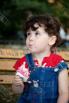 little girl is eating strawberry ice-cream