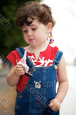 little girl is eating strawberry ice-cream