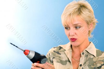 model  poses in studio with cordless drill