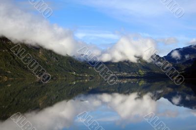 Lake with Reflection. Cloudy sky above it